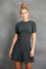 Alexa Fit and Flare Dress - VIAVAI FASHION  CLOSE UP  FRONT VIEW of a BLOND model with her hair up in a messy bun, wearing a fit andf flare knit dress in OLIVE color with beautiful textures and open knit details 